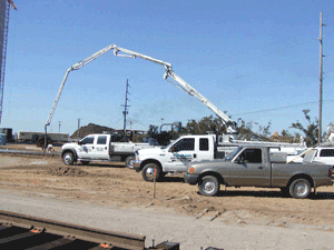 Charger crew installing a heavy duty, concrete access road for a new cement depot in Tampa, Florida.