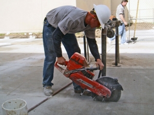 Hand operated concrete saw.