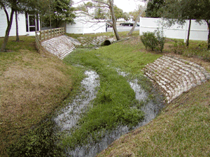 This is a picture of repaired embankments damaged by storm water erosion. In time the foundations of the adjacent buildings would have been compromised.